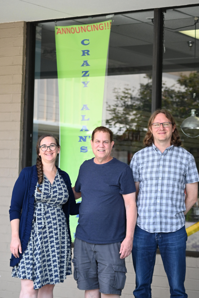 Michele, Alan, and John in front of the store